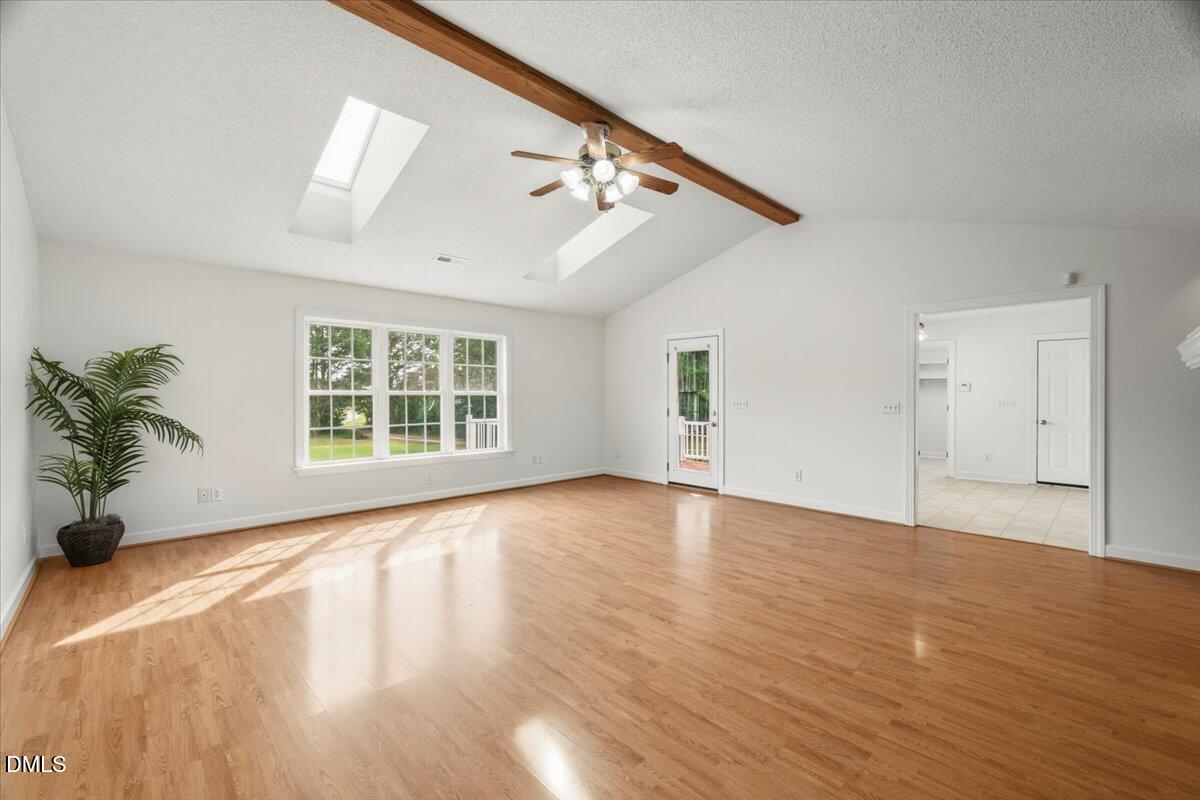685 River Run Road Selma, NC 27576 - Photo 13 of 27 a view of an empty room with wooden floor and a window
