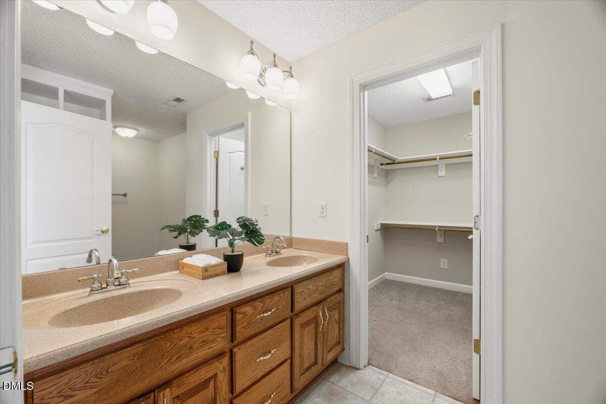 685 River Run Road Selma, NC 27576 - Photo 18 of 27 a bathroom with a double vanity sink and a mirror