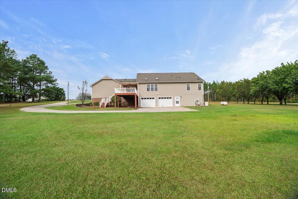 685 River Run Road Selma, NC 27576 - Photo 26 of 27 a front view of a house with garden