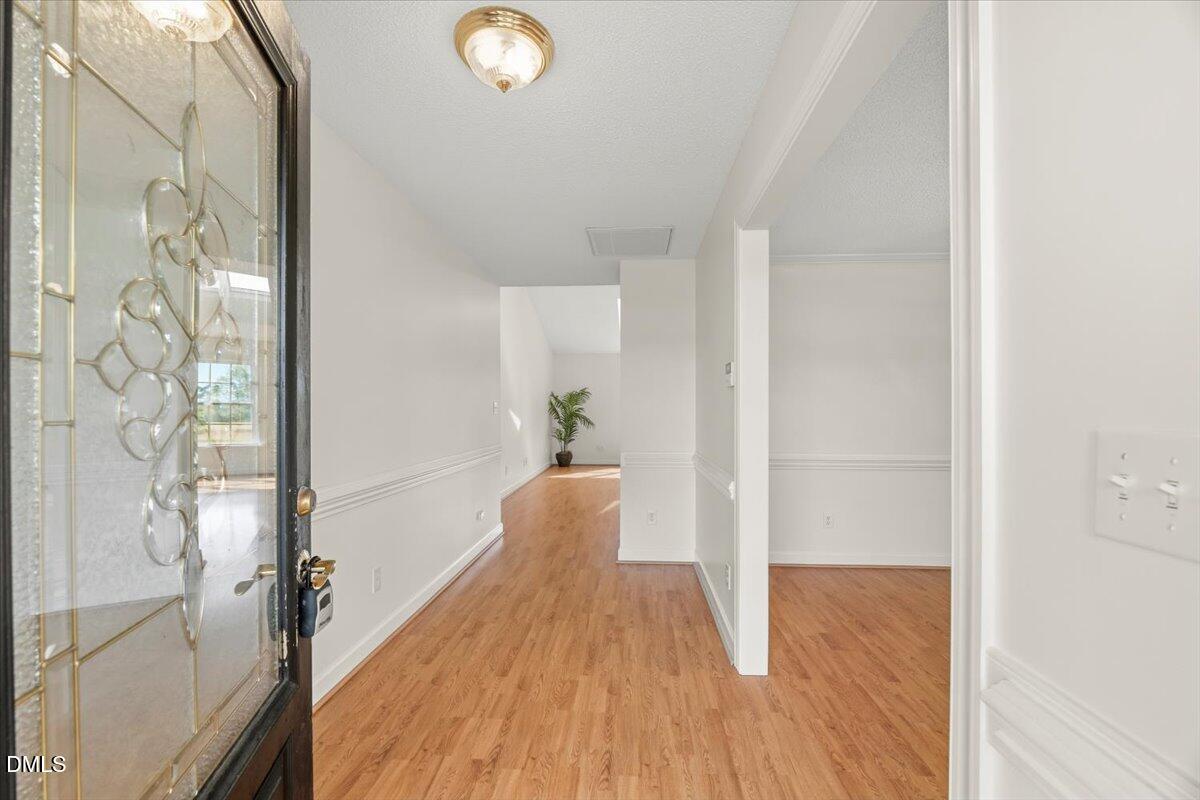 685 River Run Road Selma, NC 27576 - Photo 4 of 27 a view of a hallway with wooden floor and furniture