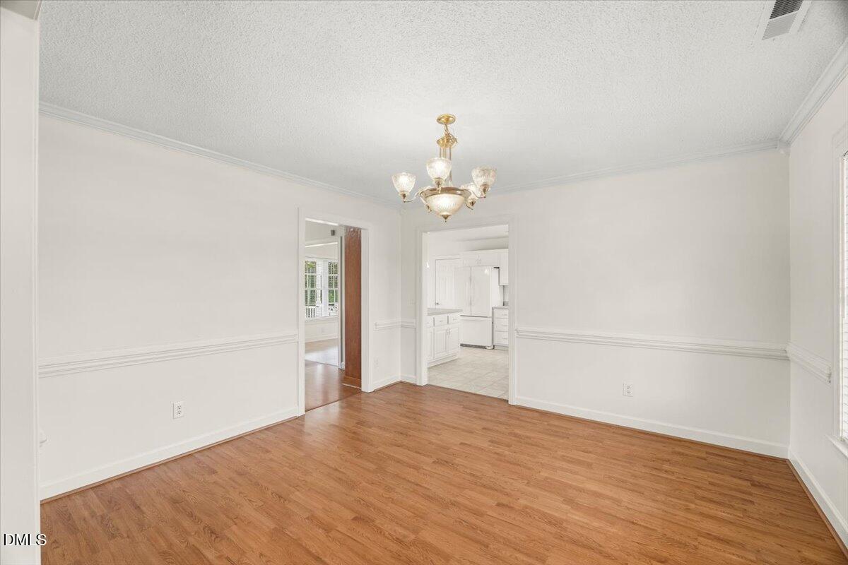 685 River Run Road Selma, NC 27576 - Photo 5 of 27 a big room with wooden floor closet and windows