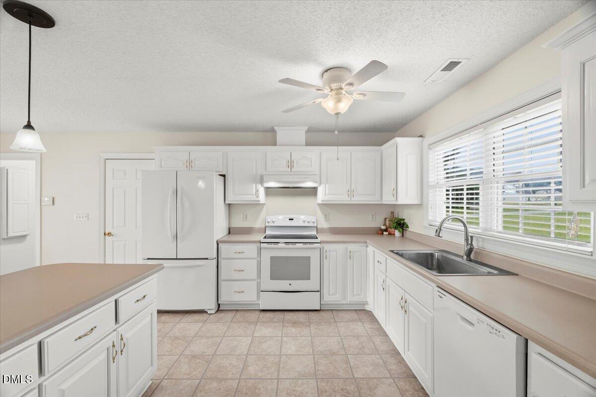 685 River Run Road Selma, NC 27576 - Photo 6 of 27 a kitchen with a stove a sink and a refrigerator