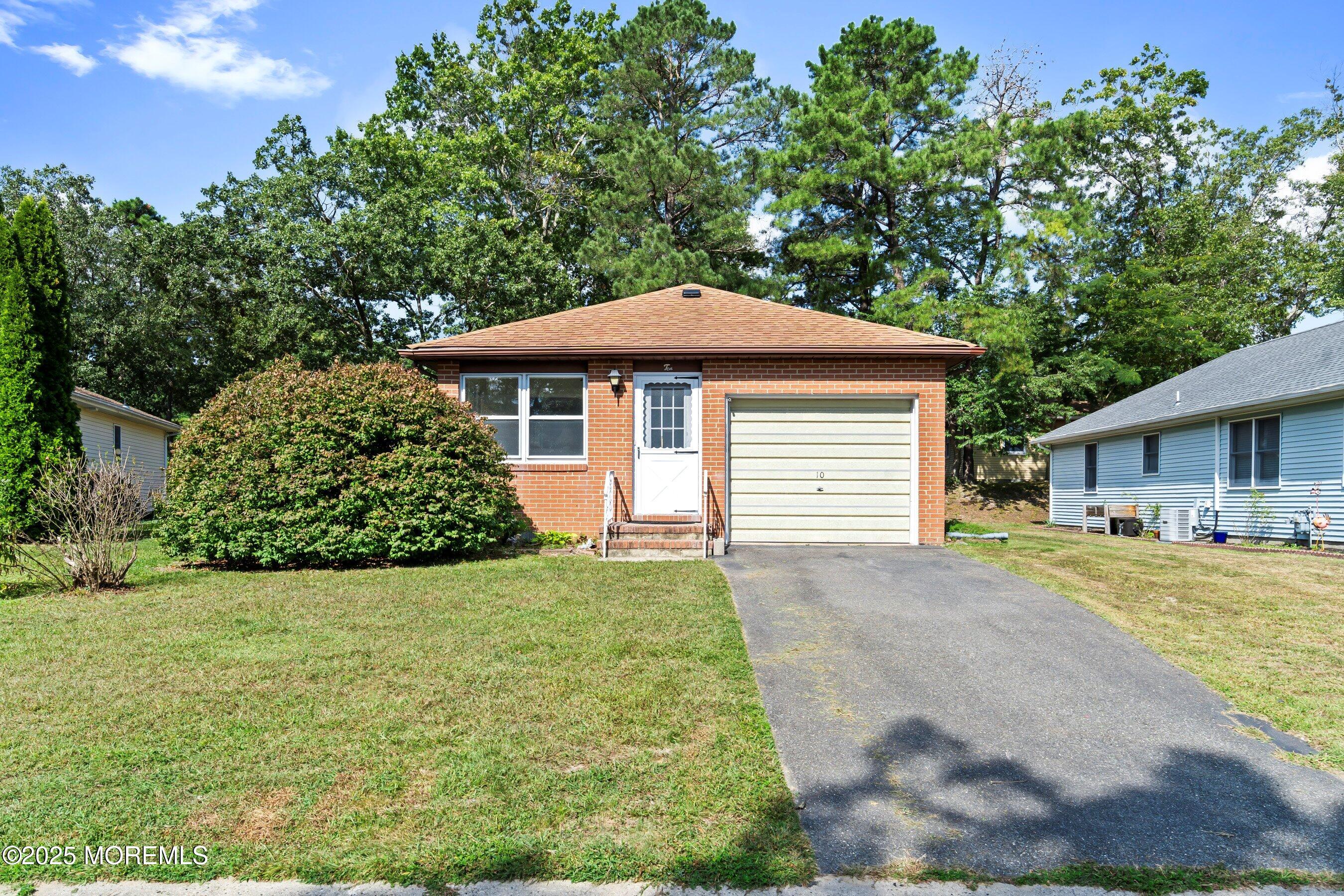 10 Magnolia Road, Unit 19 Manahawkin, NJ 08050 - Photo 1 of 30 a front view of a house with a garden
