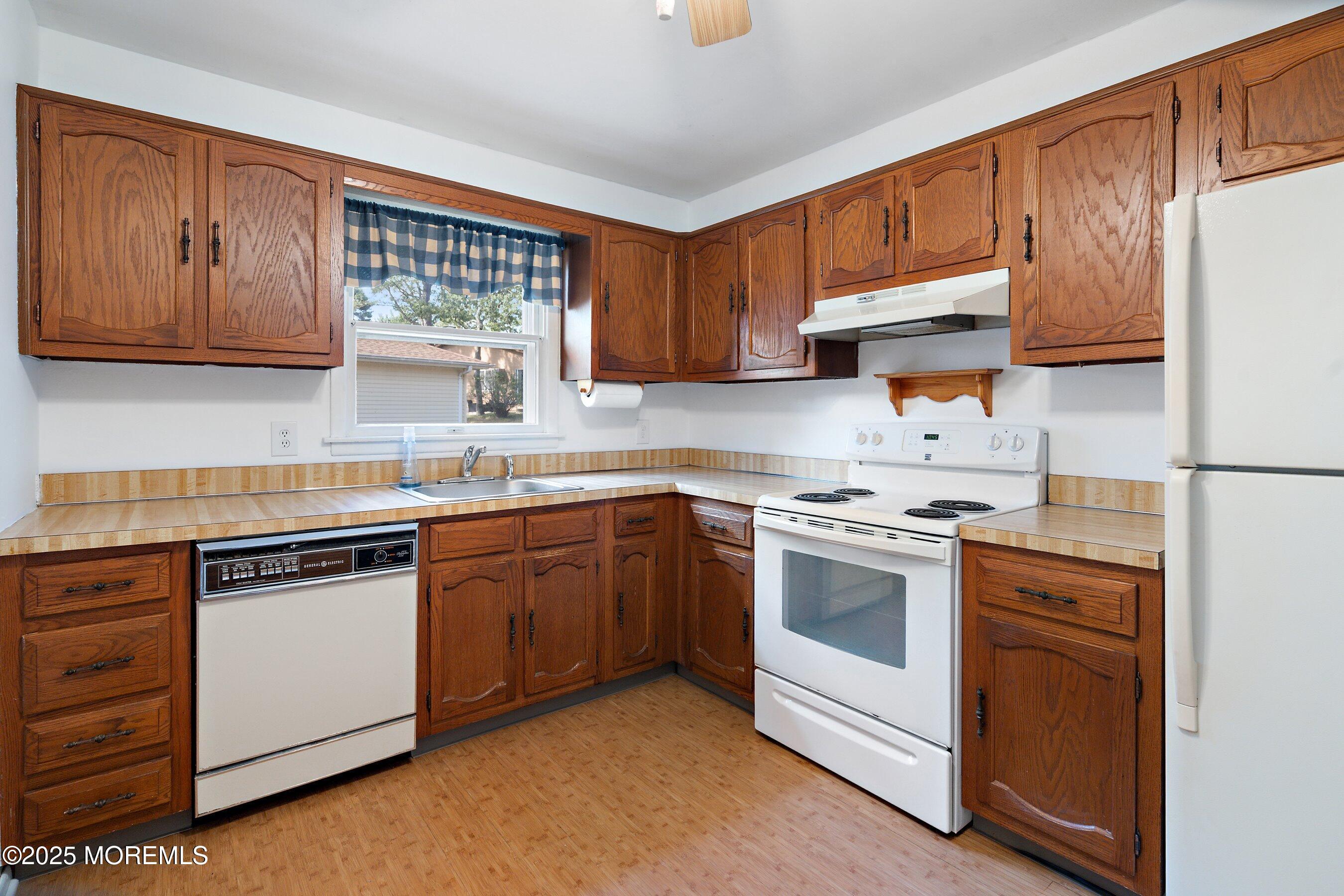 10 Magnolia Road, Unit 19 Manahawkin, NJ 08050 - Photo 11 of 30 a kitchen with stainless steel appliances granite countertop a stove sink and cabinets