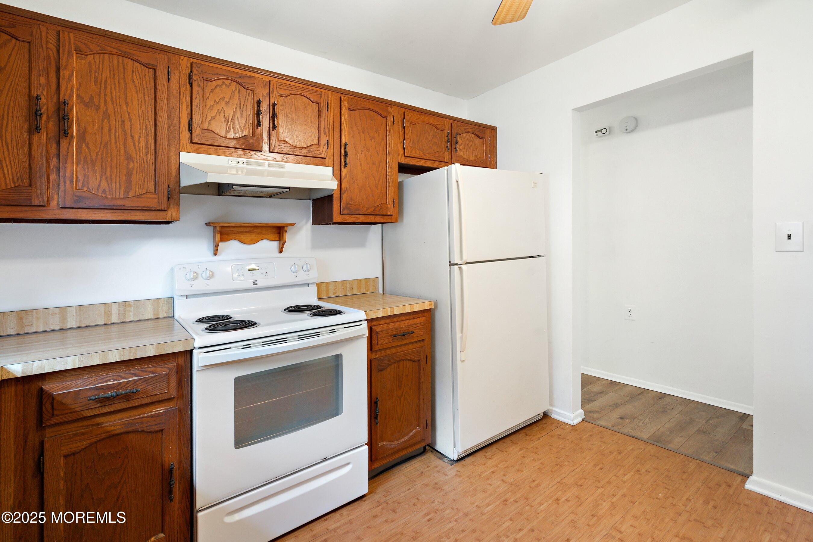 10 Magnolia Road, Unit 19 Manahawkin, NJ 08050 - Photo 12 of 30 a kitchen with a refrigerator stove and cabinets