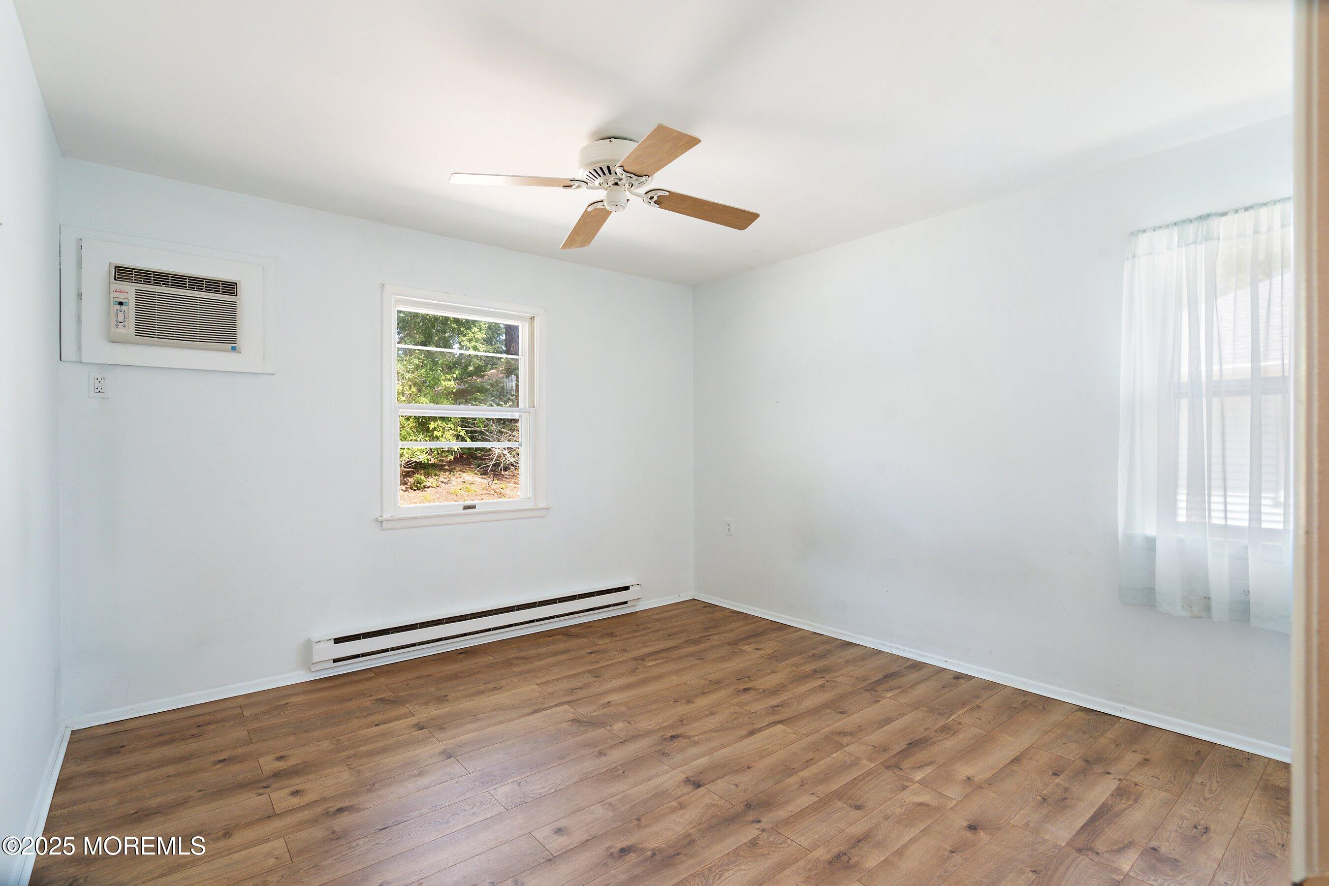10 Magnolia Road, Unit 19 Manahawkin, NJ 08050 - Photo 16 of 30 wooden floor in an empty room with a window