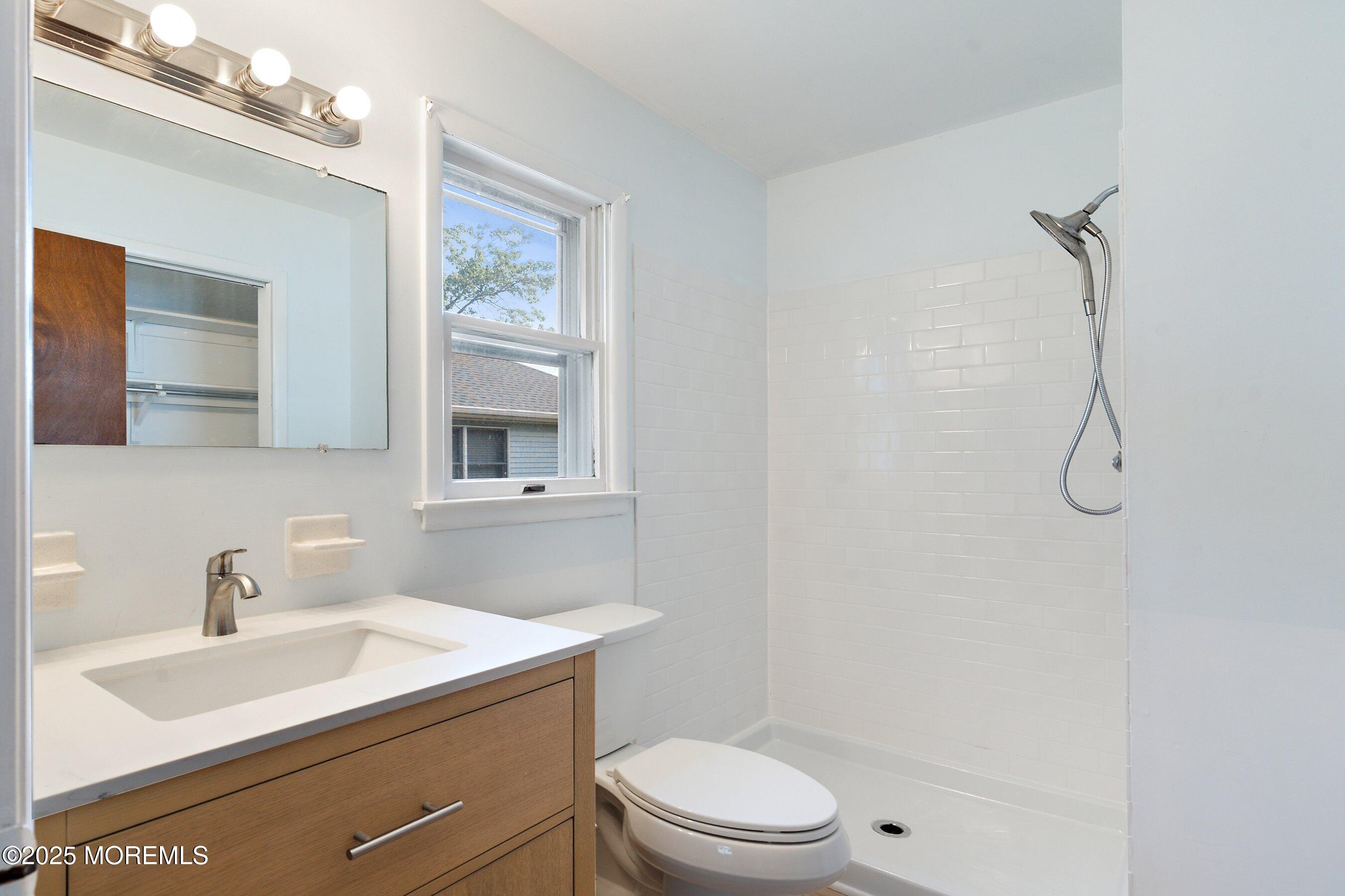 10 Magnolia Road, Unit 19 Manahawkin, NJ 08050 - Photo 17 of 30 a bathroom with a sink a toilet and shower