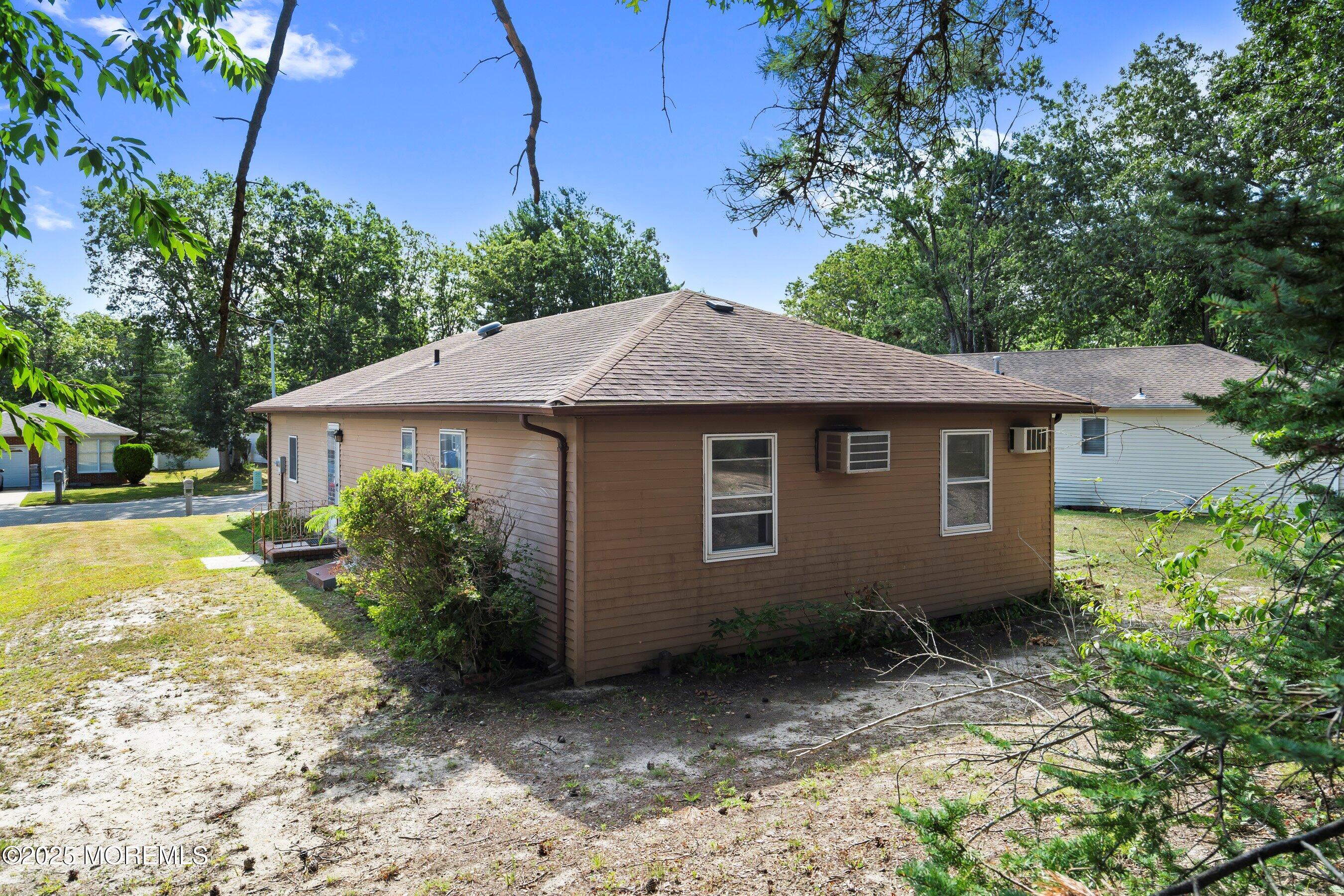 10 Magnolia Road, Unit 19 Manahawkin, NJ 08050 - Photo 21 of 30 a view of a house with a yard plants and large tree
