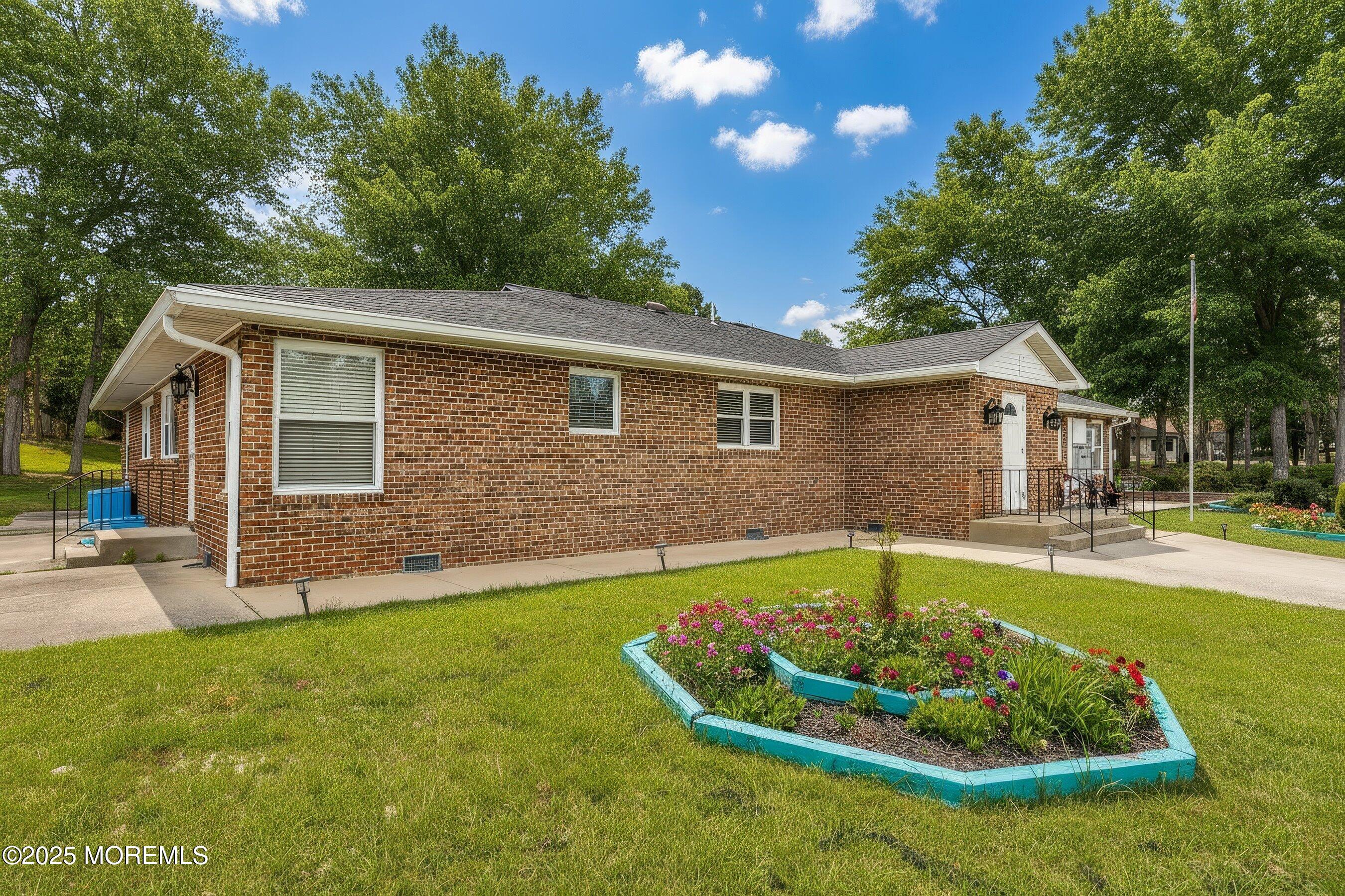 10 Magnolia Road, Unit 19 Manahawkin, NJ 08050 - Photo 24 of 30 a view of a house with a swimming pool and a yard
