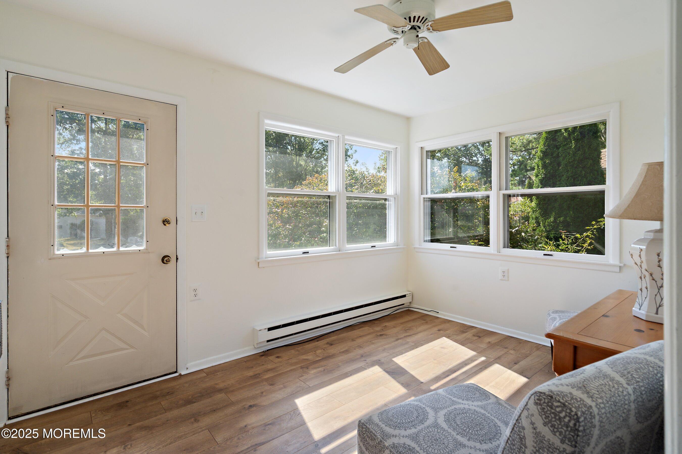 10 Magnolia Road, Unit 19 Manahawkin, NJ 08050 - Photo 4 of 30 a view of a room with windows and a ceiling fan