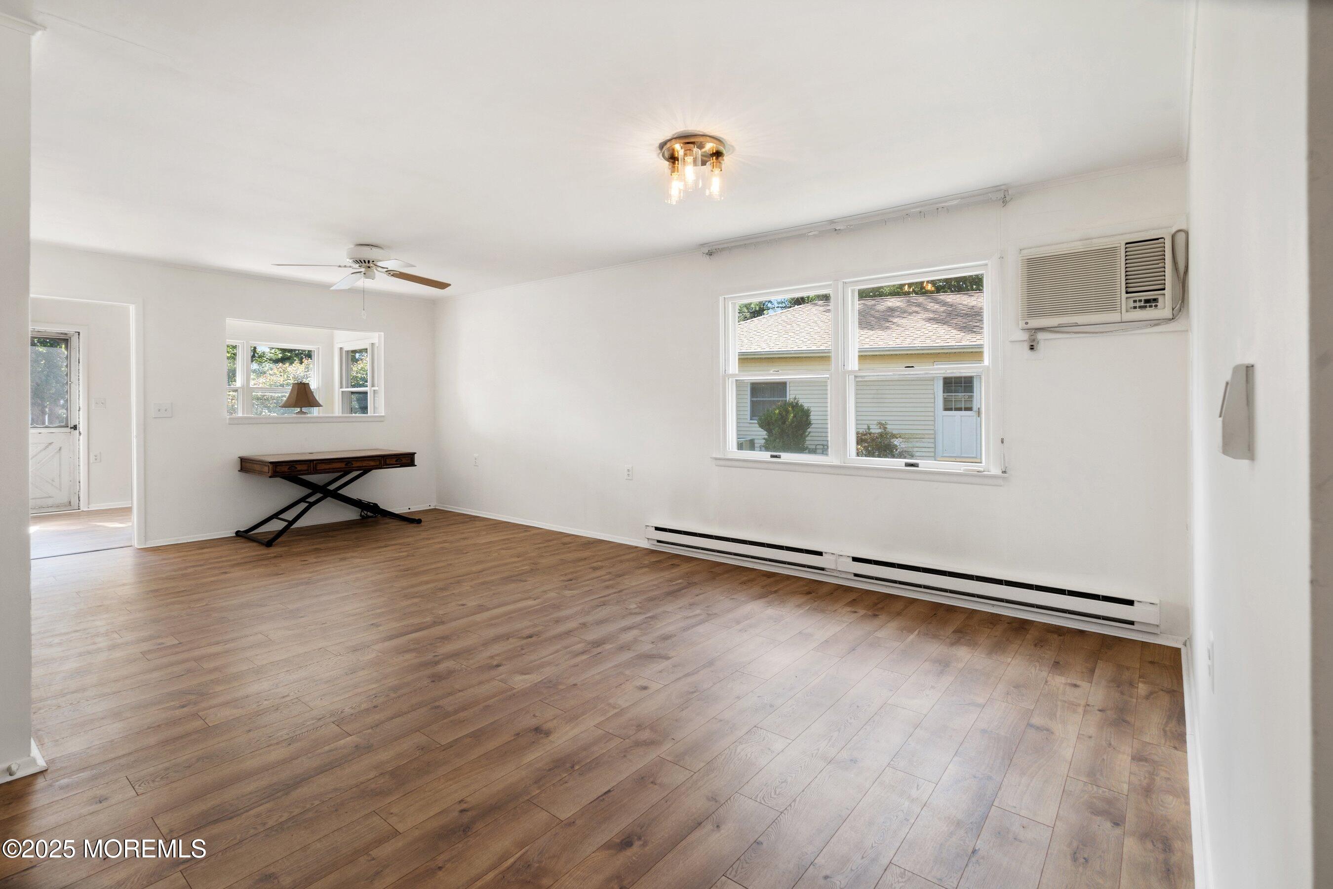 10 Magnolia Road, Unit 19 Manahawkin, NJ 08050 - Photo 6 of 30 an empty room with wooden floor and windows