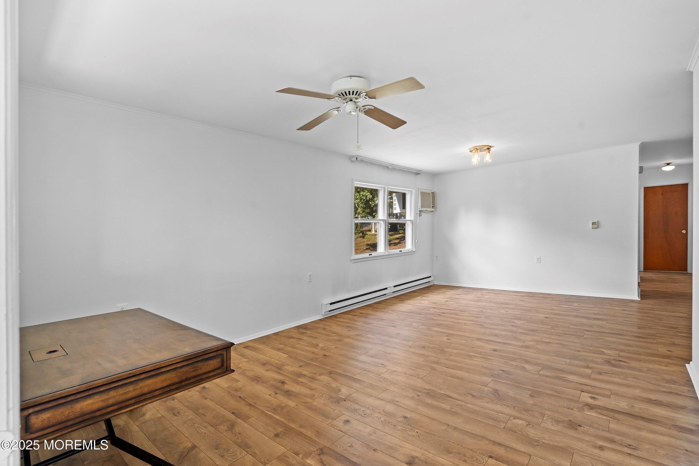 10 Magnolia Road, Unit 19 Manahawkin, NJ 08050 - Photo 7 of 30 wooden floor in an empty room with a window