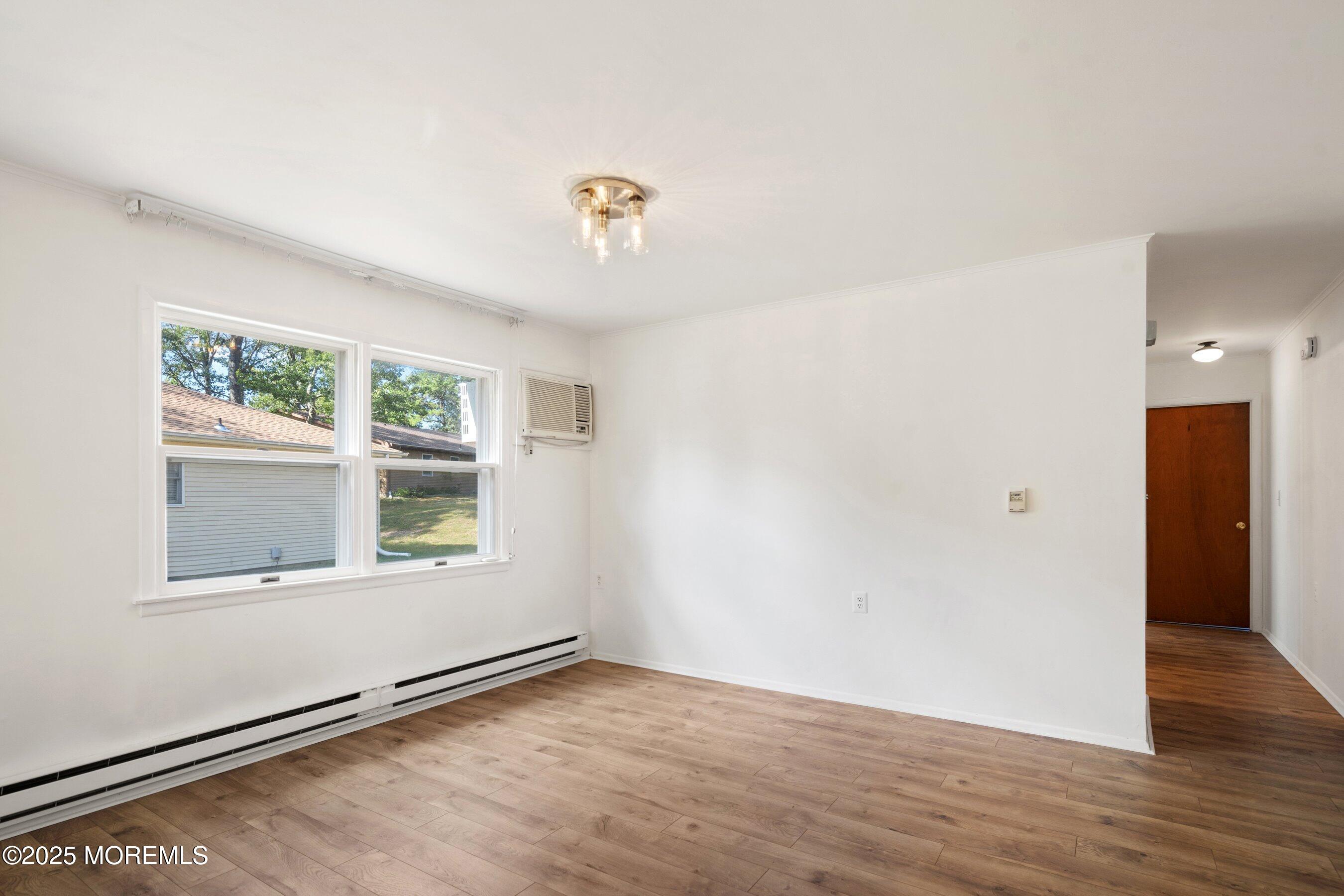 10 Magnolia Road, Unit 19 Manahawkin, NJ 08050 - Photo 9 of 30 an empty room with wooden floor and windows