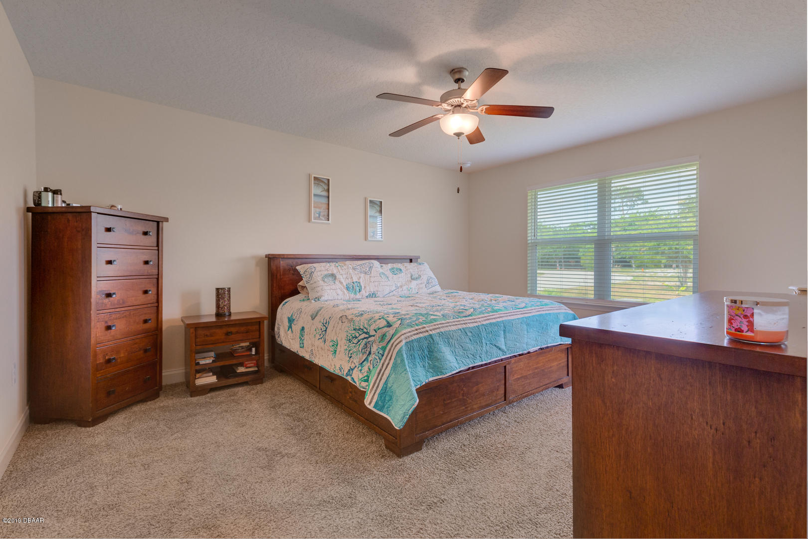 30 Turtle Ridge Drive Flagler Beach, FL 32136 - Photo 12 of 34 a bedroom with a bed and a chandelier