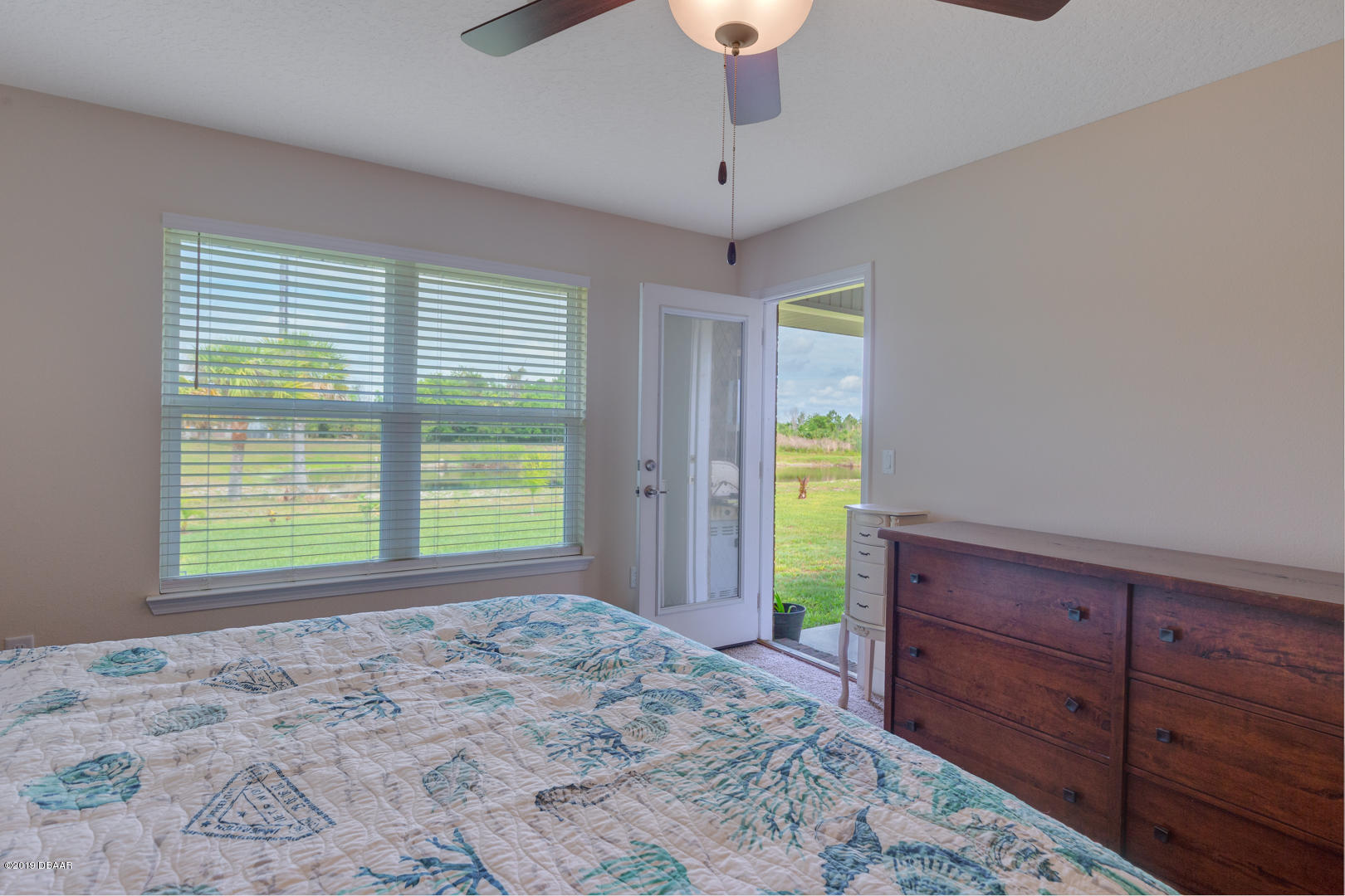 30 Turtle Ridge Drive Flagler Beach, FL 32136 - Photo 13 of 34 a view of a bedroom with a window and ceiling fan