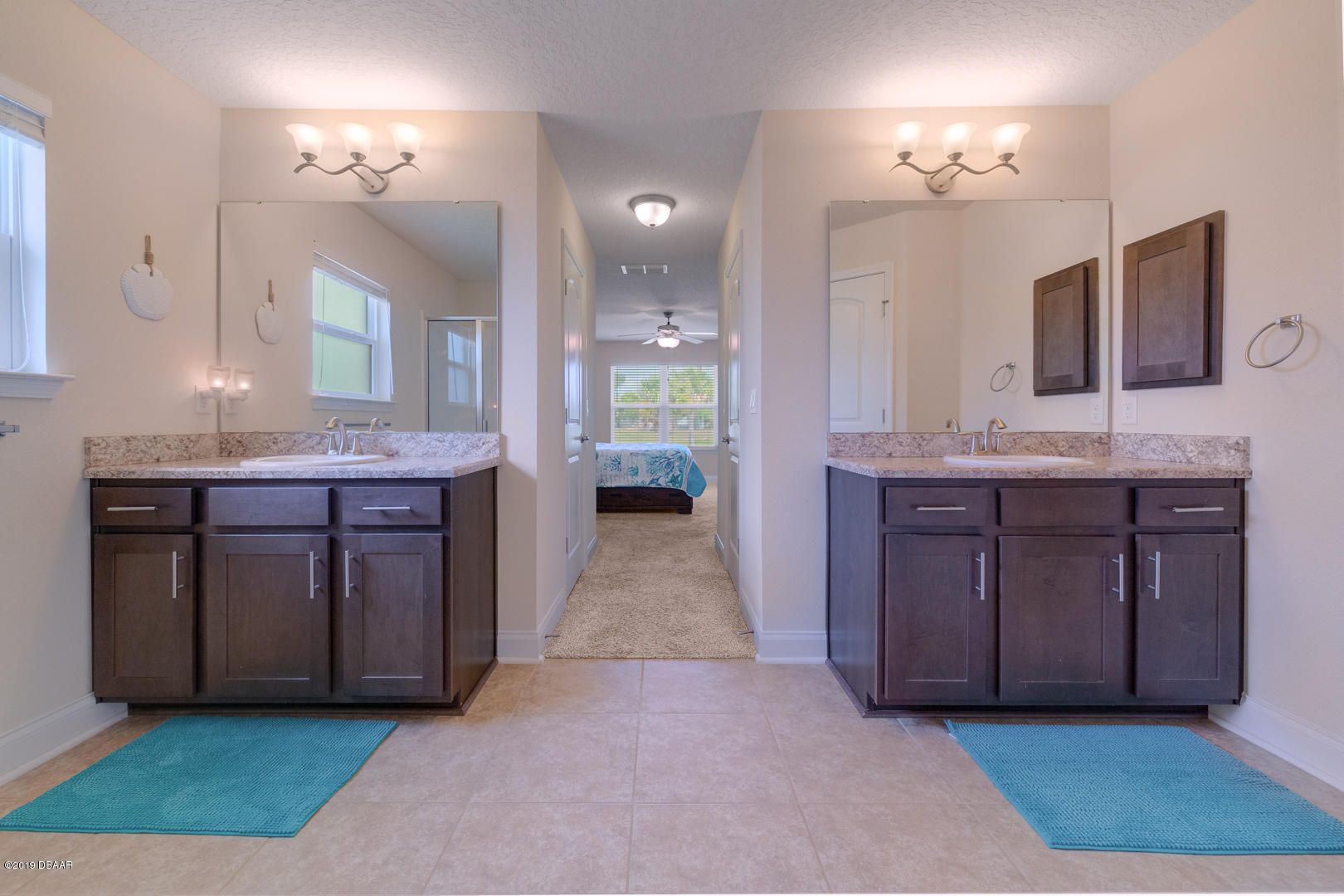 30 Turtle Ridge Drive Flagler Beach, FL 32136 - Photo 15 of 34 a spacious bathroom with a granite countertop double vanity sink and a mirror