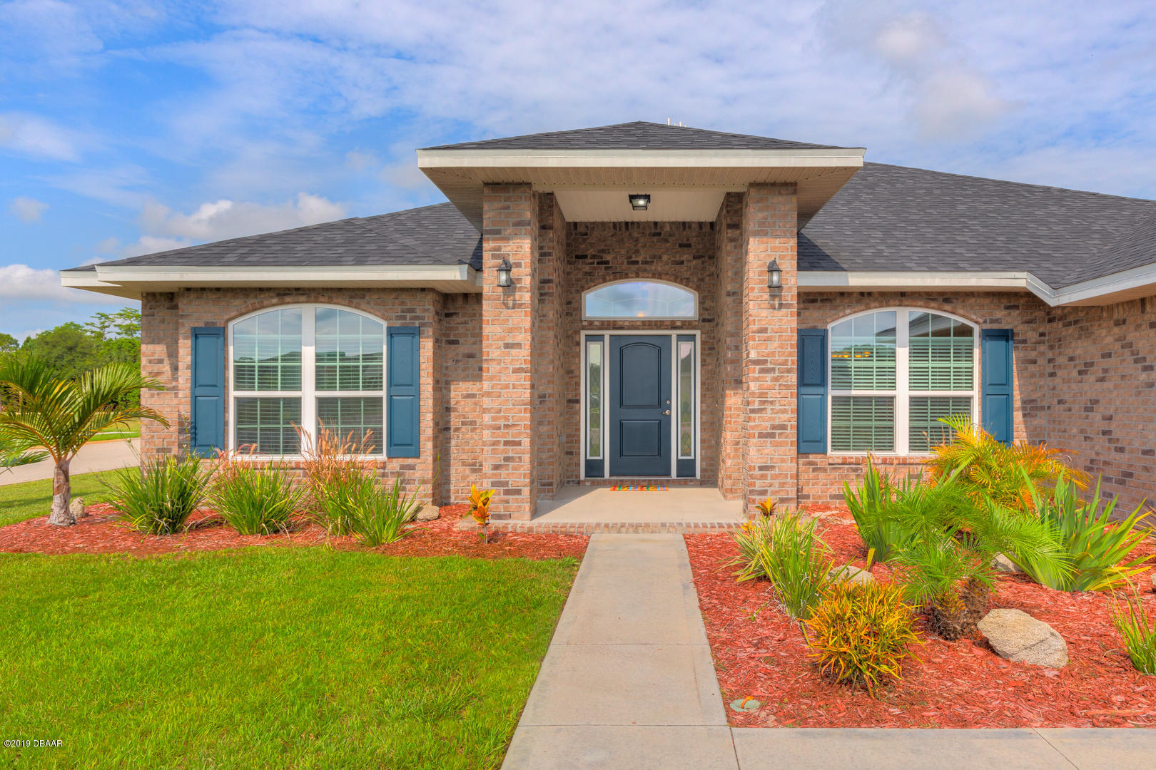 30 Turtle Ridge Drive Flagler Beach, FL 32136 - Photo 2 of 34 a front view of a house with garden