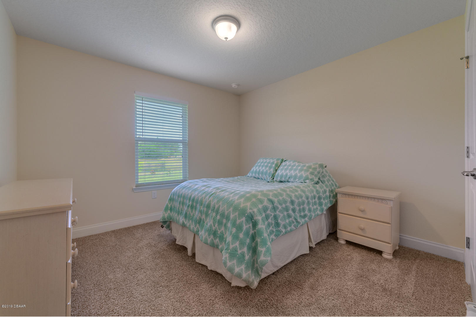 30 Turtle Ridge Drive Flagler Beach, FL 32136 - Photo 21 of 34 a spacious bedroom with a bed and a window