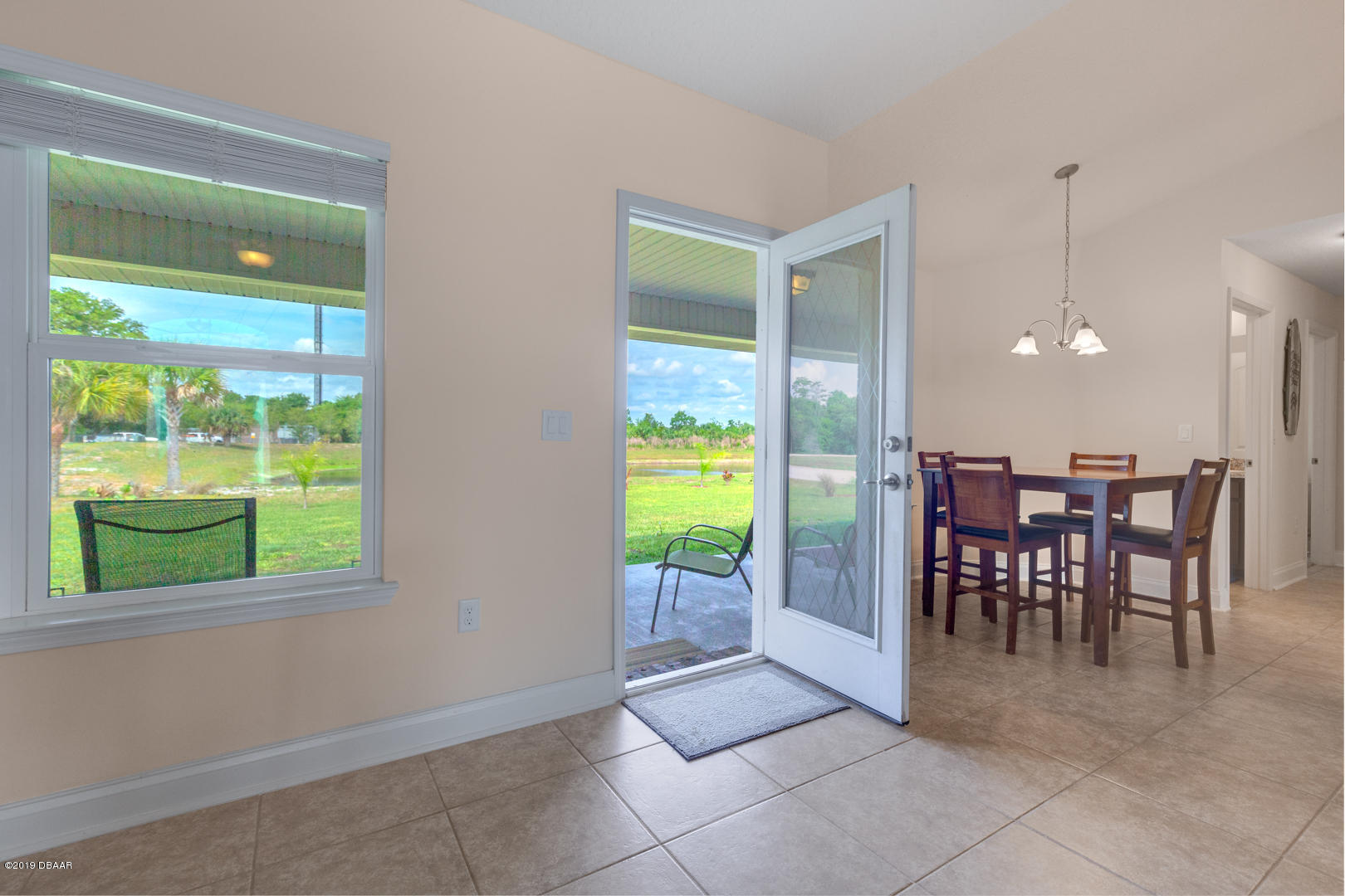 30 Turtle Ridge Drive Flagler Beach, FL 32136 - Photo 23 of 34 a view of a dining room with furniture and a floor to ceiling window