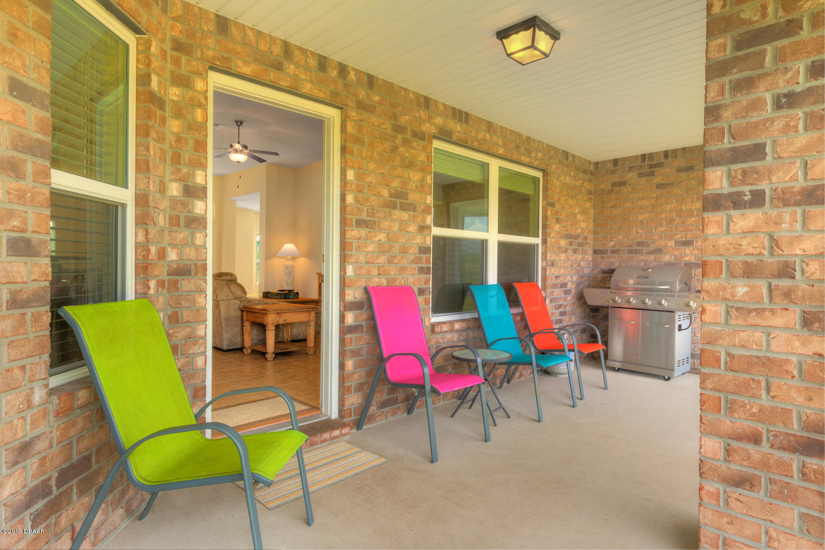30 Turtle Ridge Drive Flagler Beach, FL 32136 - Photo 24 of 34 a chair and table sitting in front of a building