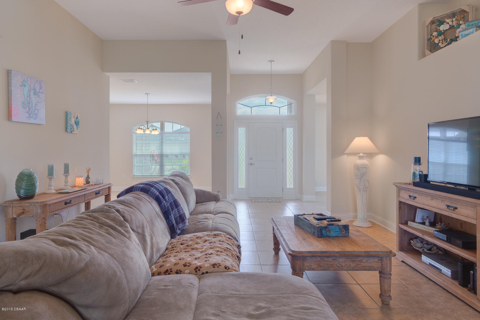 30 Turtle Ridge Drive Flagler Beach, FL 32136 - Photo 6 of 34 a living room with furniture a lamp and a chandelier