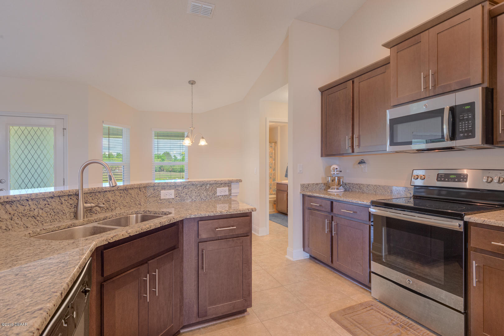 30 Turtle Ridge Drive Flagler Beach, FL 32136 - Photo 10 of 34 a kitchen with stainless steel appliances granite countertop a sink stove oven and granite counter tops