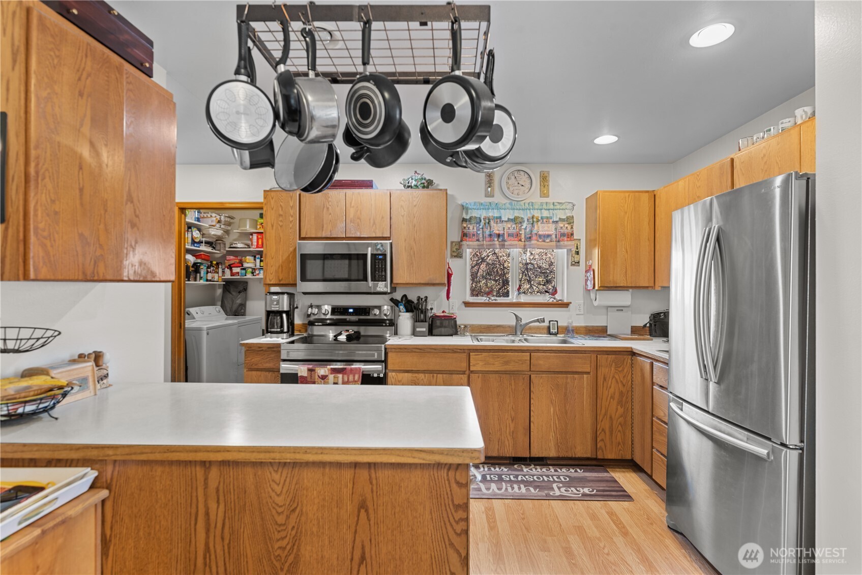 3152 Bermuda Street Malaga, WA 98828 - Photo 14 of 37 a kitchen with stainless steel appliances granite countertop a refrigerator a stove and a sink with wooden floor