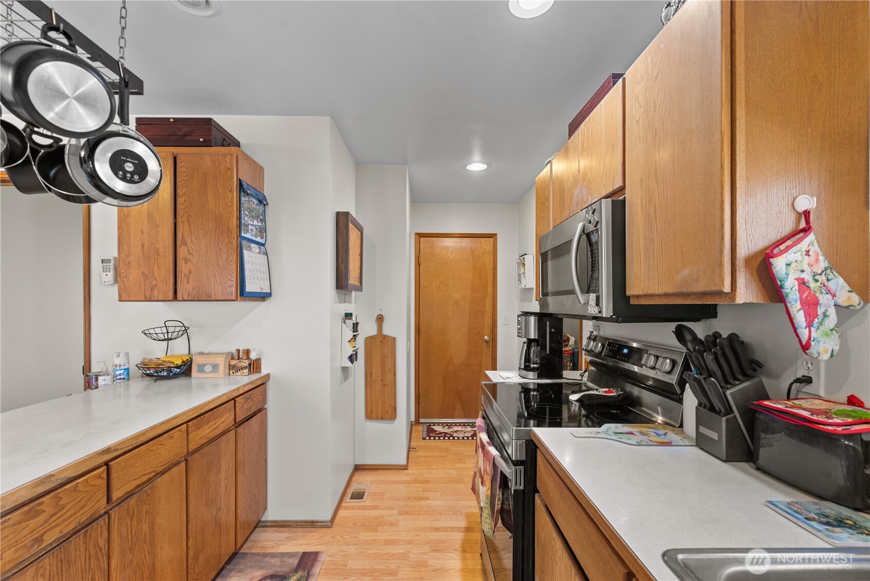 3152 Bermuda Street Malaga, WA 98828 - Photo 17 of 37 a kitchen that has a lot of cabinets a sink and a stove in it