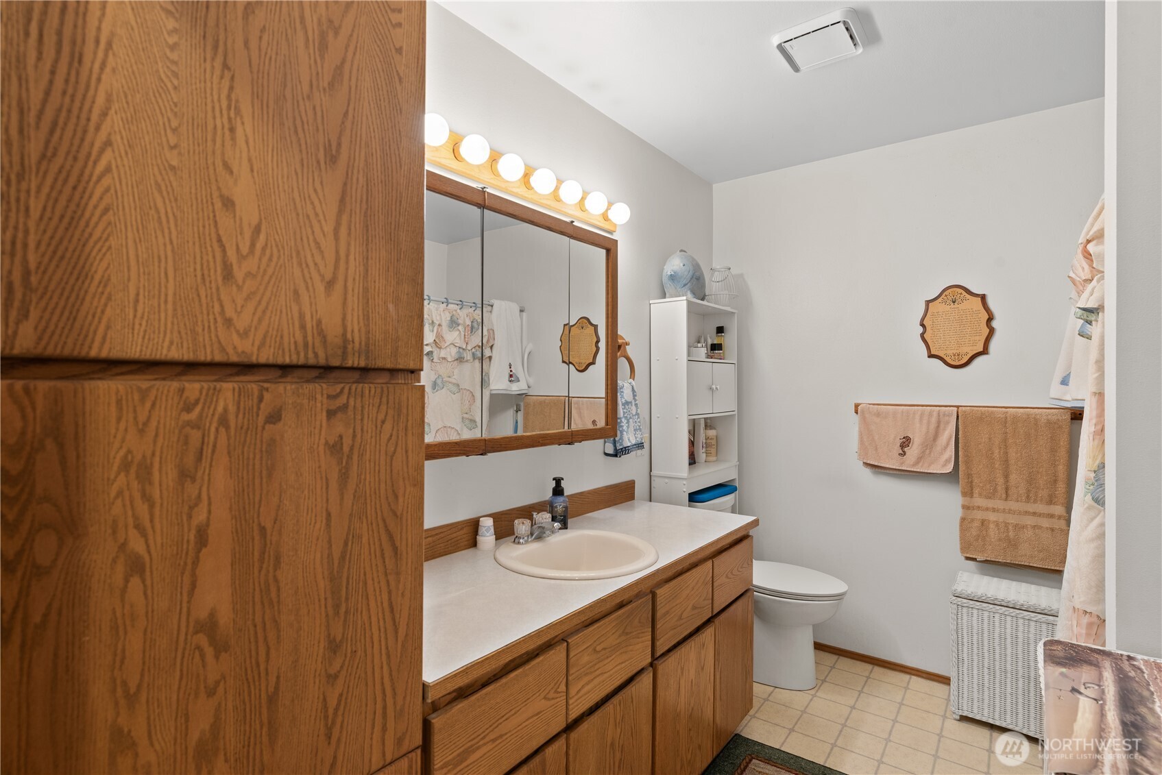 3152 Bermuda Street Malaga, WA 98828 - Photo 20 of 37 a bathroom with a sink mirror vanity and toilet