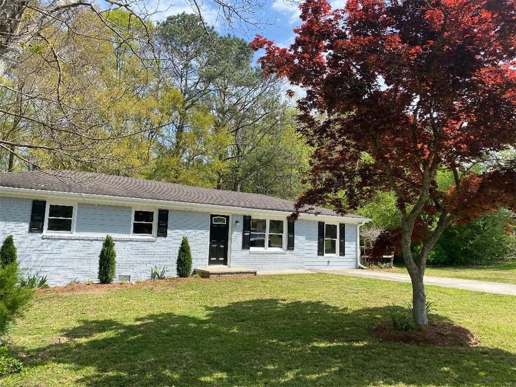 3574 Ridgecrest Drive Powder Springs, GA 30127 - Photo 1 of 1 a front view of house with yard and trees in the background