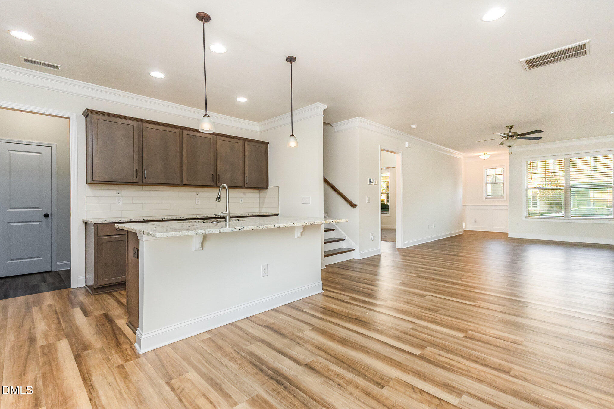 824 Country Downs Road Wake Forest, NC 27587 - Photo 11 of 43 a view of kitchen with stainless steel appliances granite countertop wooden floors and a sink