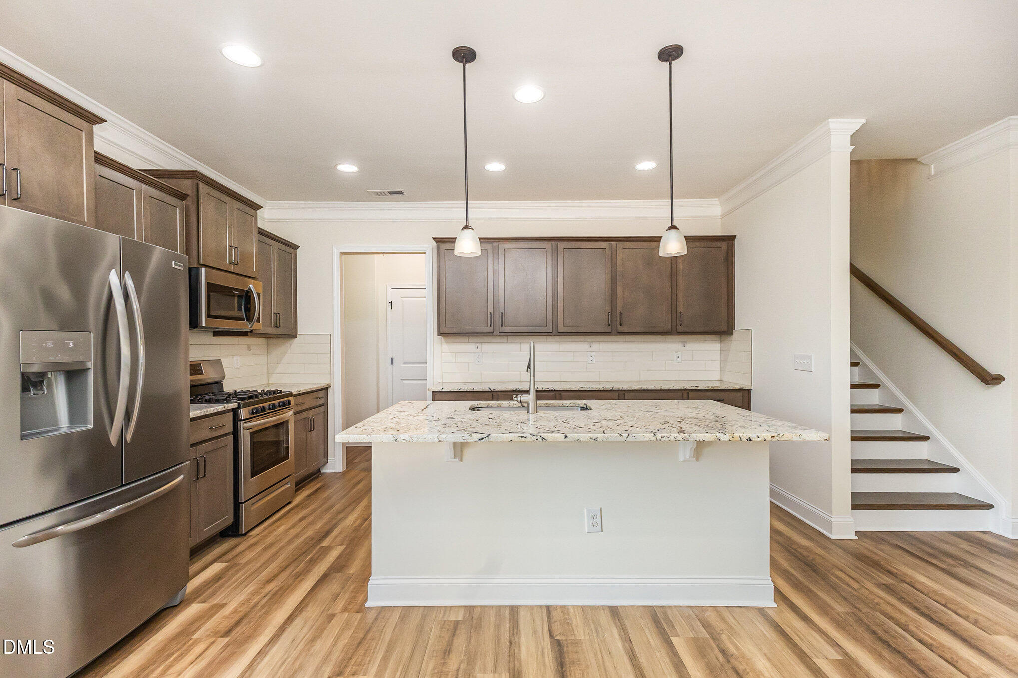824 Country Downs Road Wake Forest, NC 27587 - Photo 12 of 43 a kitchen with stainless steel appliances granite countertop a sink a stove and a refrigerator