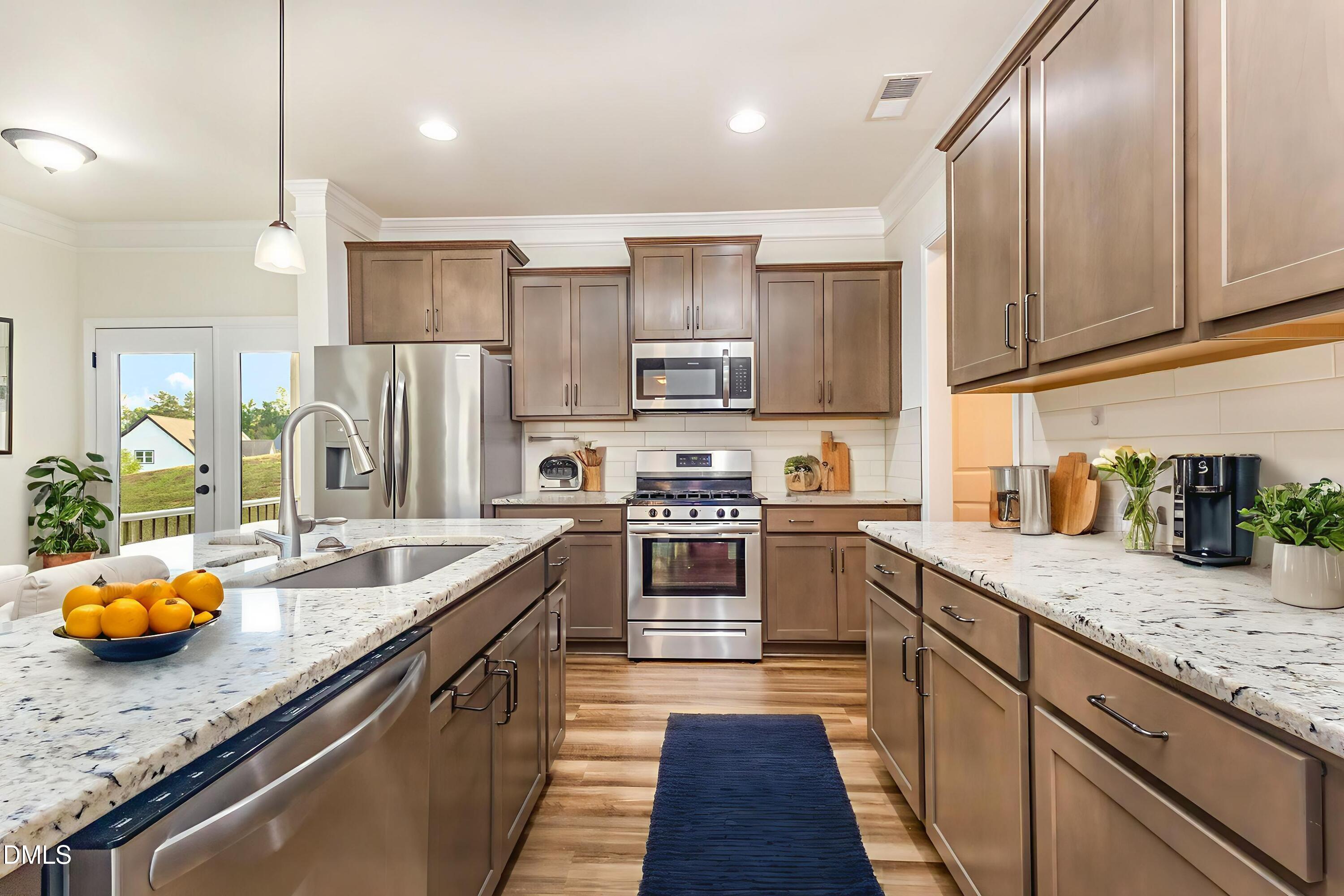 824 Country Downs Road Wake Forest, NC 27587 - Photo 13 of 43 a kitchen with stainless steel appliances granite countertop a sink stove and refrigerator