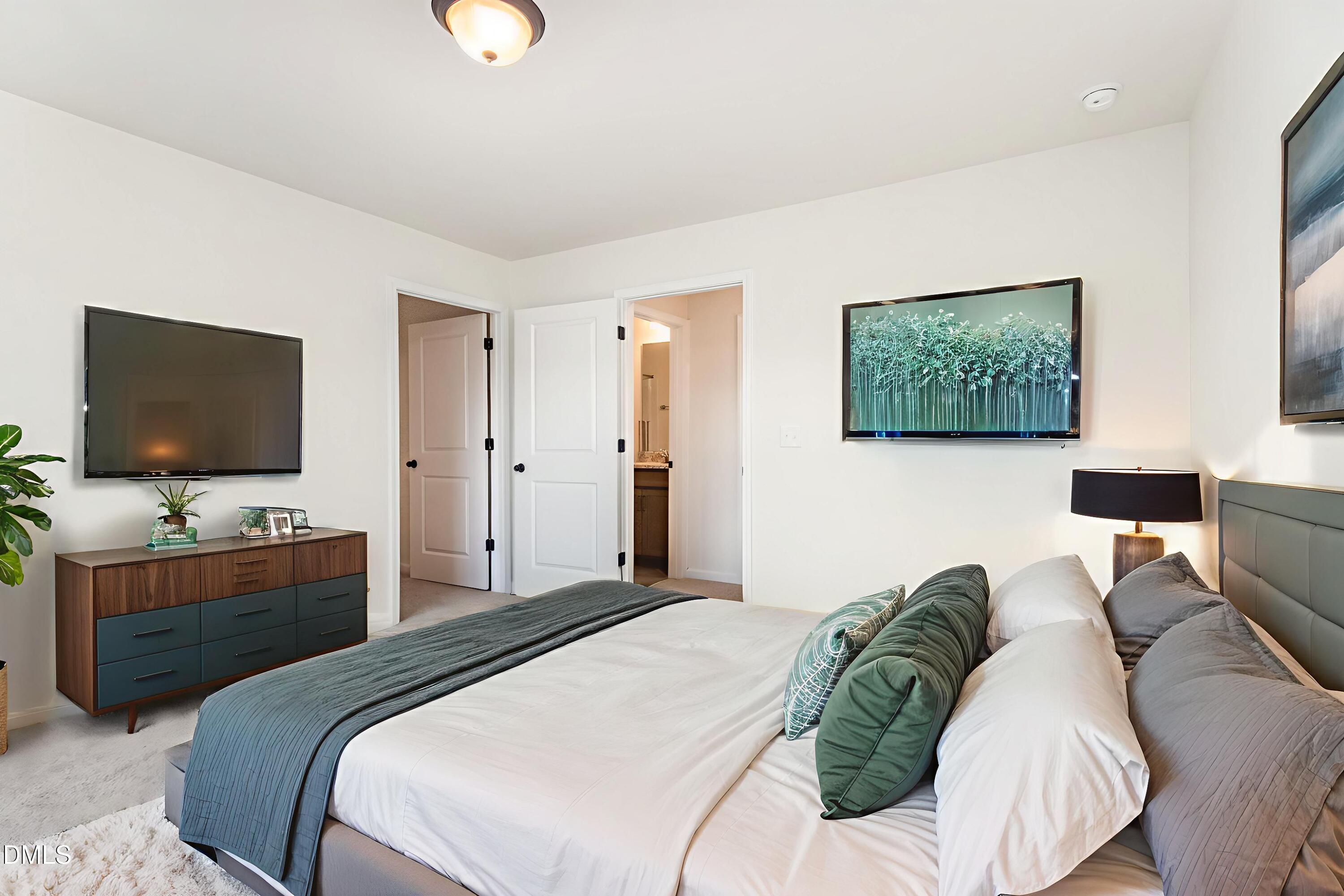 824 Country Downs Road Wake Forest, NC 27587 - Photo 26 of 43 a bedroom with a bed and a flat screen tv