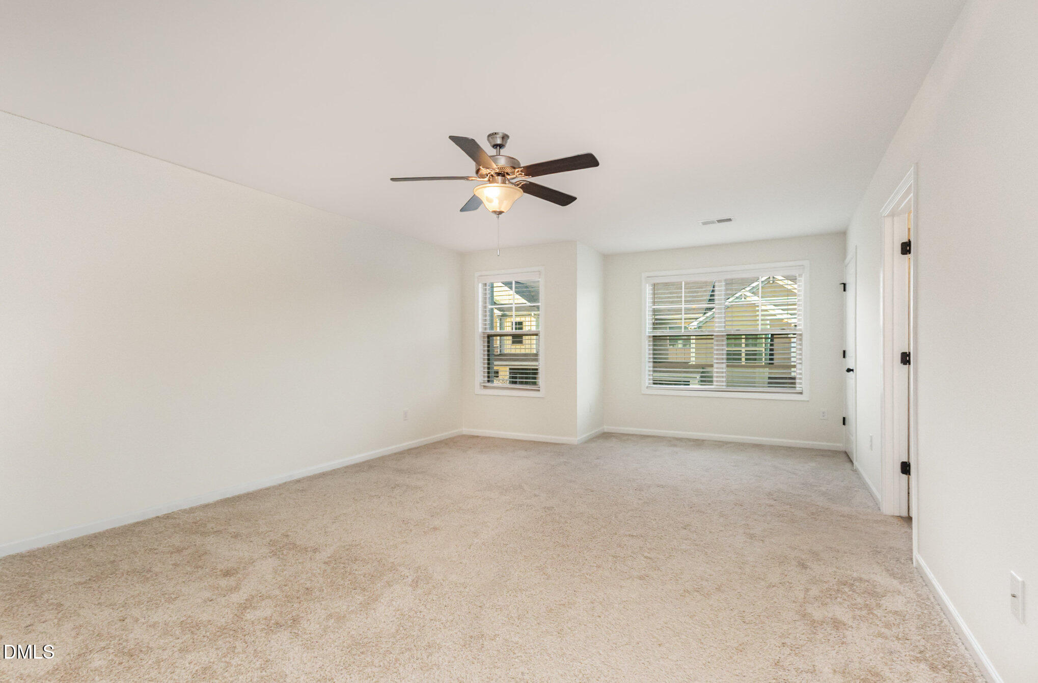 824 Country Downs Road Wake Forest, NC 27587 - Photo 29 of 43 an empty room with windows and fan