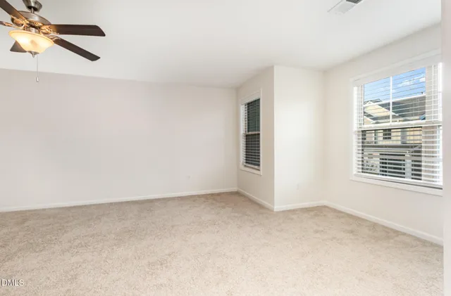 a view of a livingroom with a ceiling fan and entryway