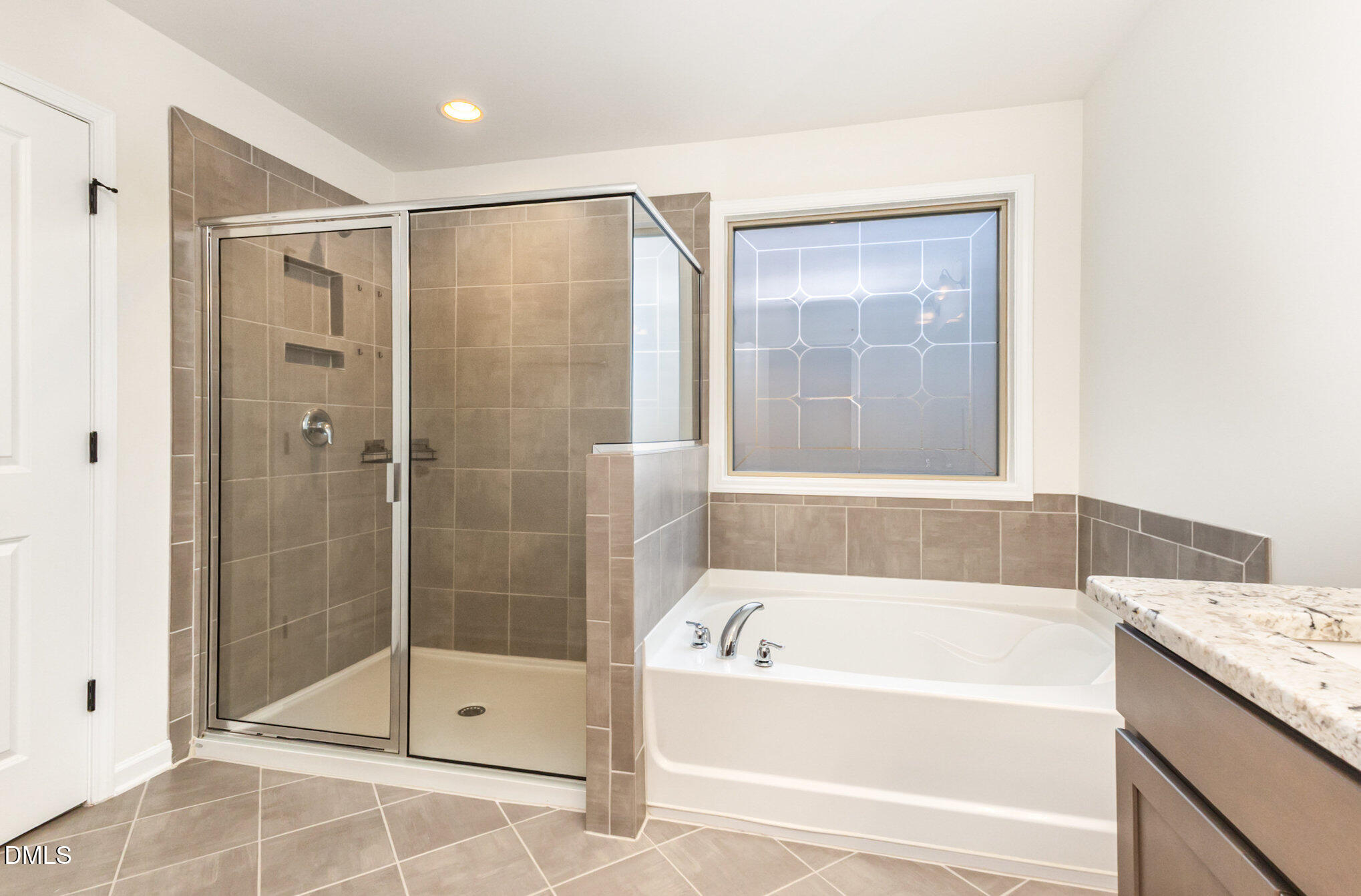 824 Country Downs Road Wake Forest, NC 27587 - Photo 34 of 43 a bathroom with a bathtub and a shower