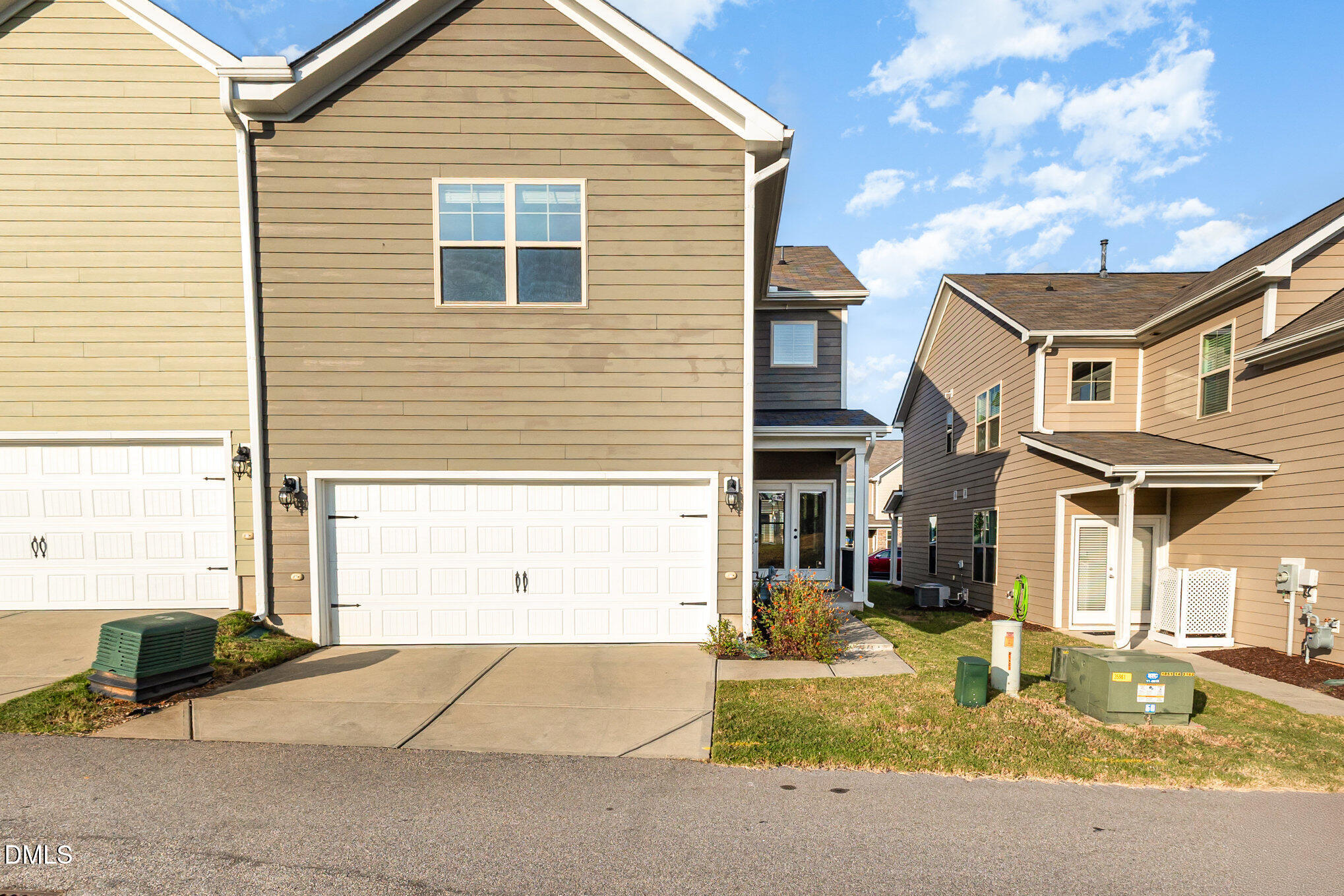 824 Country Downs Road Wake Forest, NC 27587 - Photo 39 of 43 a view of a white house with a large windows and a yard