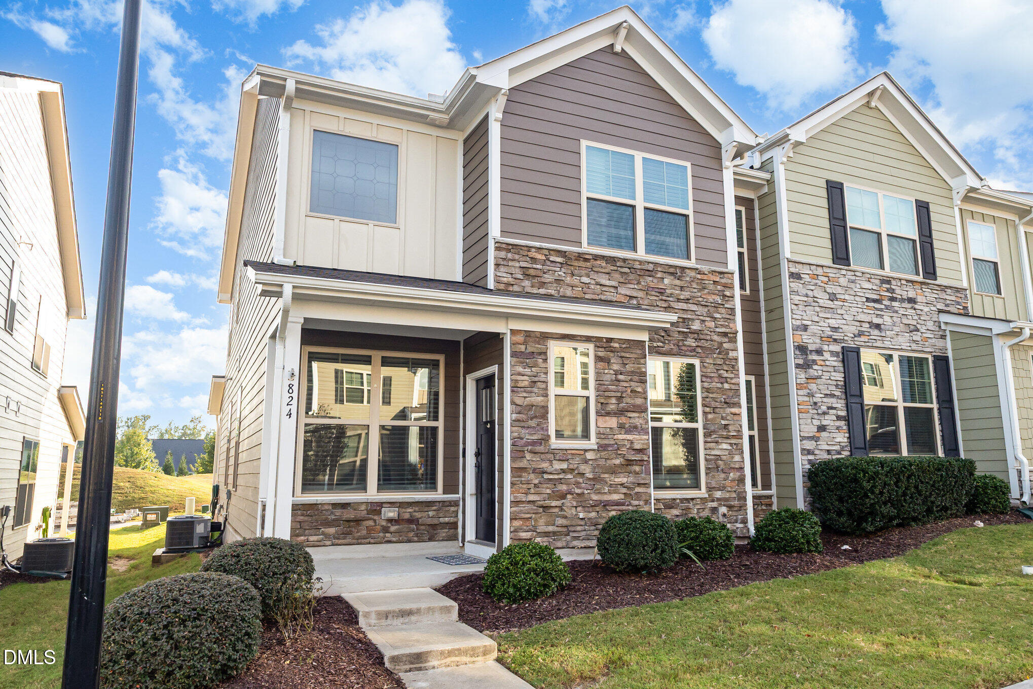 824 Country Downs Road Wake Forest, NC 27587 - Photo 4 of 43 a view of a brick house with many windows next to a yard