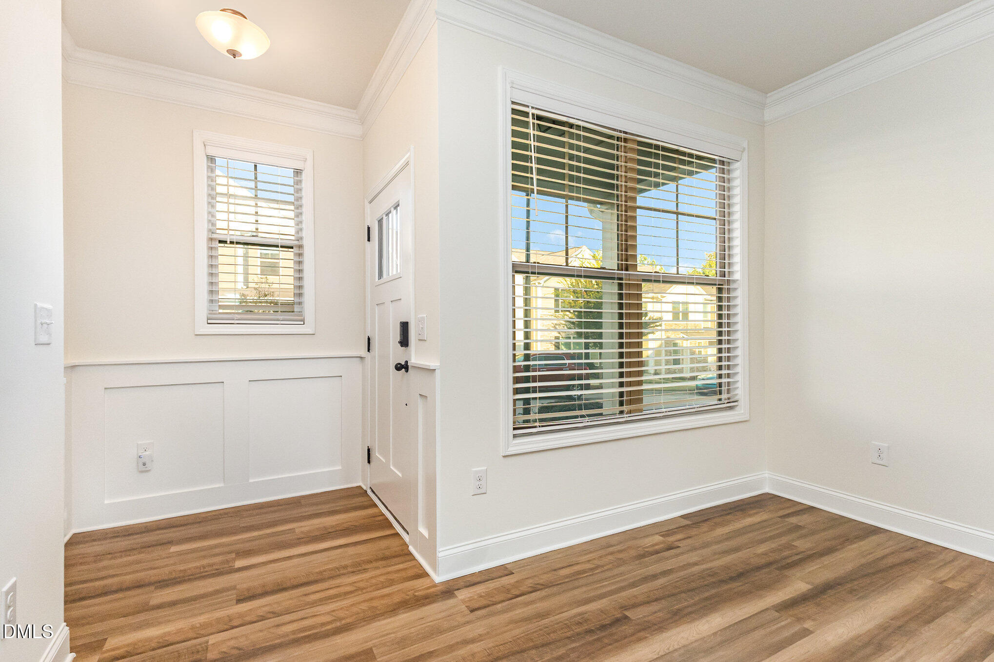 824 Country Downs Road Wake Forest, NC 27587 - Photo 7 of 43 a view of an empty room with wooden floor and a window