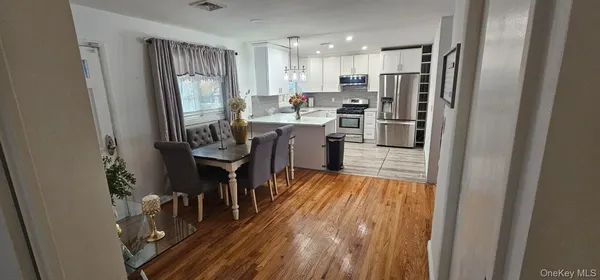 a kitchen with a refrigerator a sink and a stove top oven
