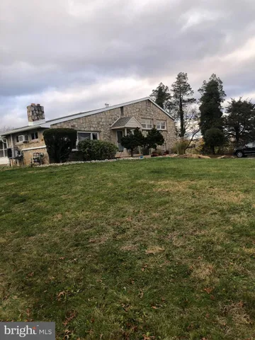 a view of a big yard with plants and a houses