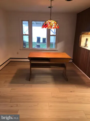 a room with pool table and windows