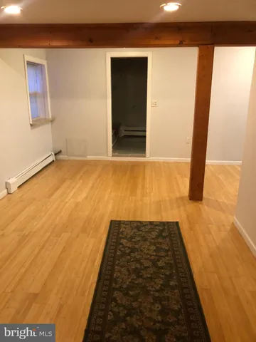 a view of hallway with wooden floor