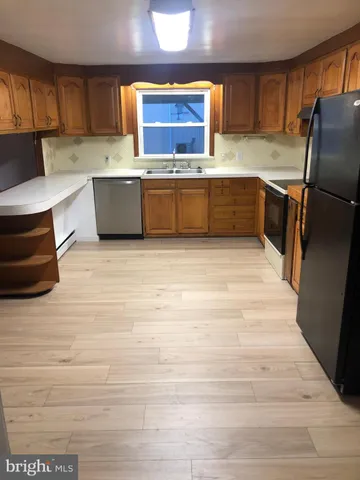 a kitchen with stainless steel appliances granite countertop a sink and cabinets