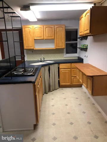 a kitchen with stainless steel appliances a sink stove and microwave