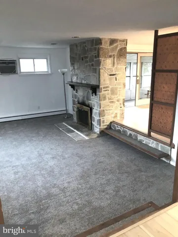 a view of empty room with a fireplace