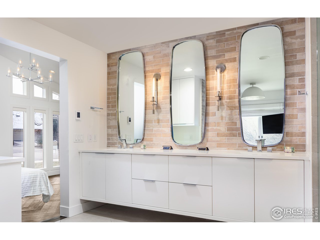 5315 Centennial Trail Boulder, CO 80303 - Photo 13 of 40 Oh the primary suite bathroom and closet. Divine! Stone walls. Under counter refrigerator. Built-in vanity seating.