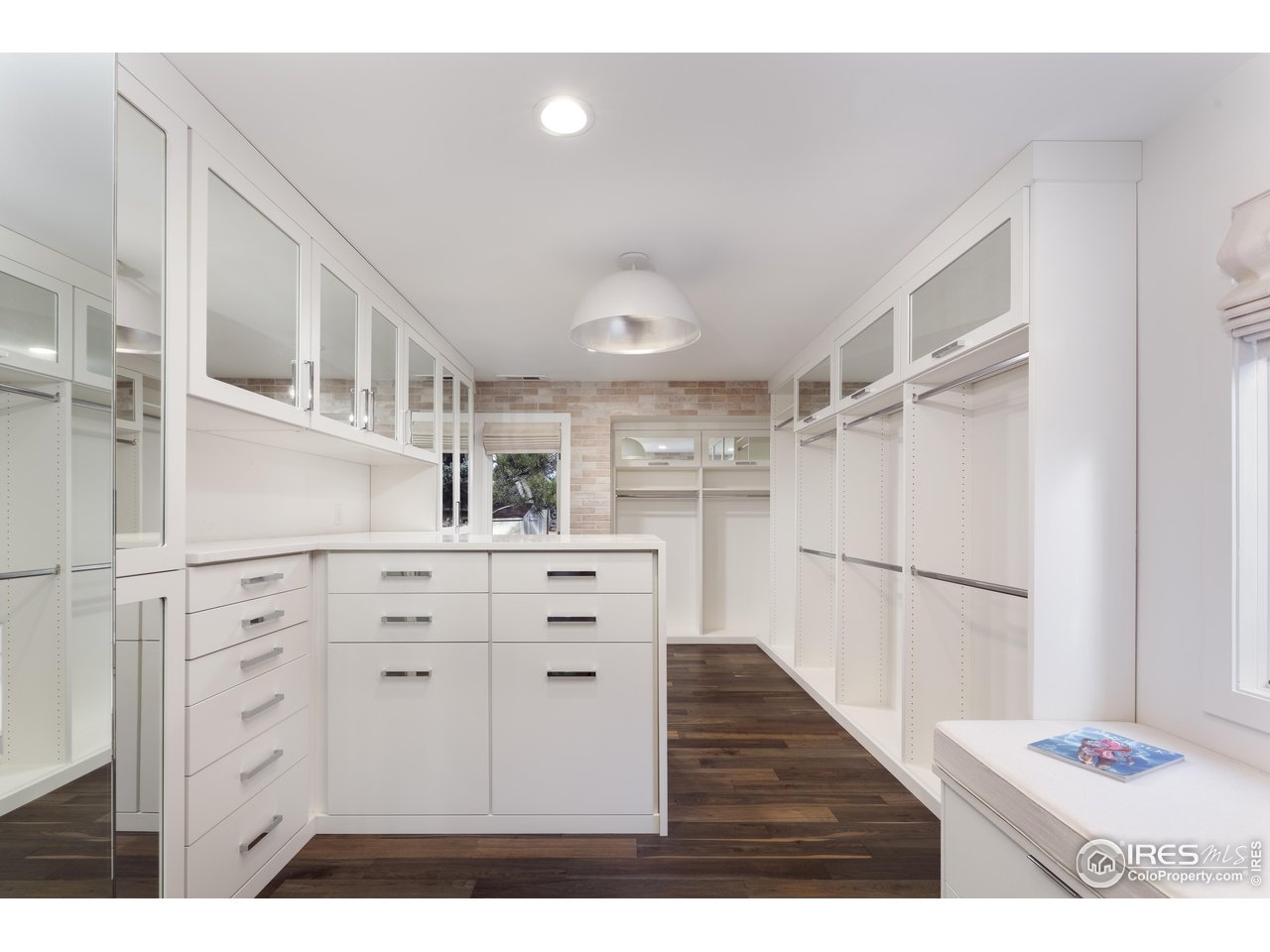 5315 Centennial Trail Boulder, CO 80303 - Photo 18 of 40 Stunning, dreamy, marvelous primary suite closet. 160sf! Built-in seating #2. Tharp Cabinet company throughout. Jewelry & tie drawers, dual clothes hampers...every luxurious detail covered.