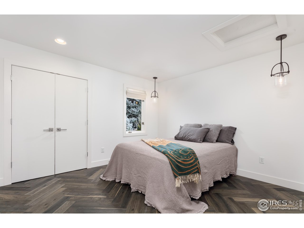 5315 Centennial Trail Boulder, CO 80303 - Photo 27 of 40 2nd spacious bedroom with mounted tv that conveys, custom closet cabinetry and shelving and a gorgeous bathroom across the hall.